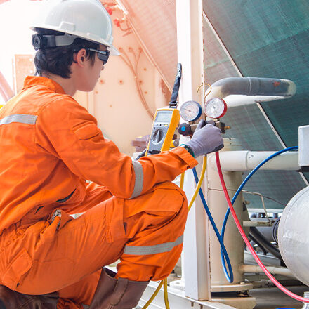 Electrician measuring voltage and logging data in log sheet, electrical service at offshore.