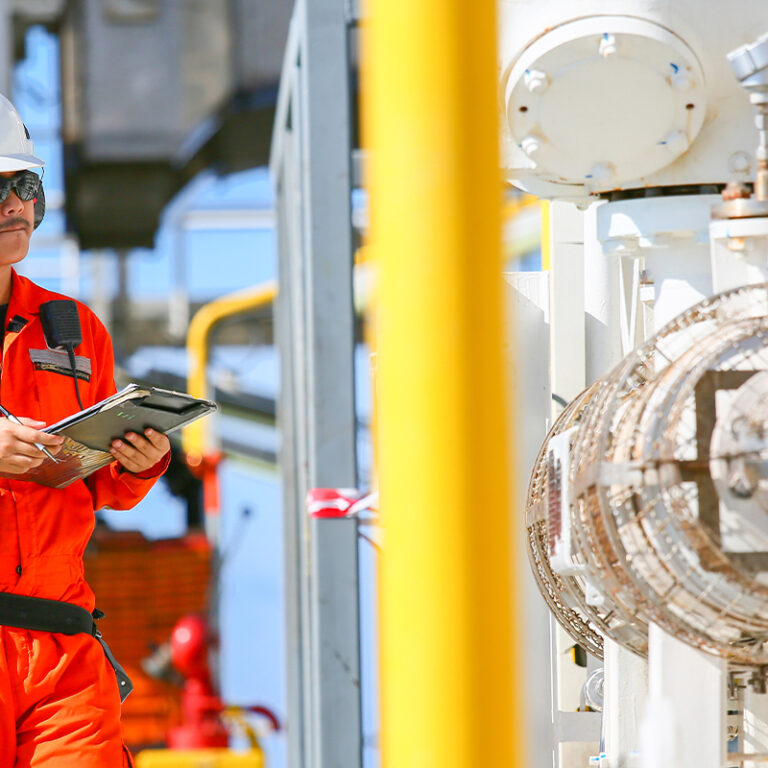Worker on an offshore oil platform checking equipment