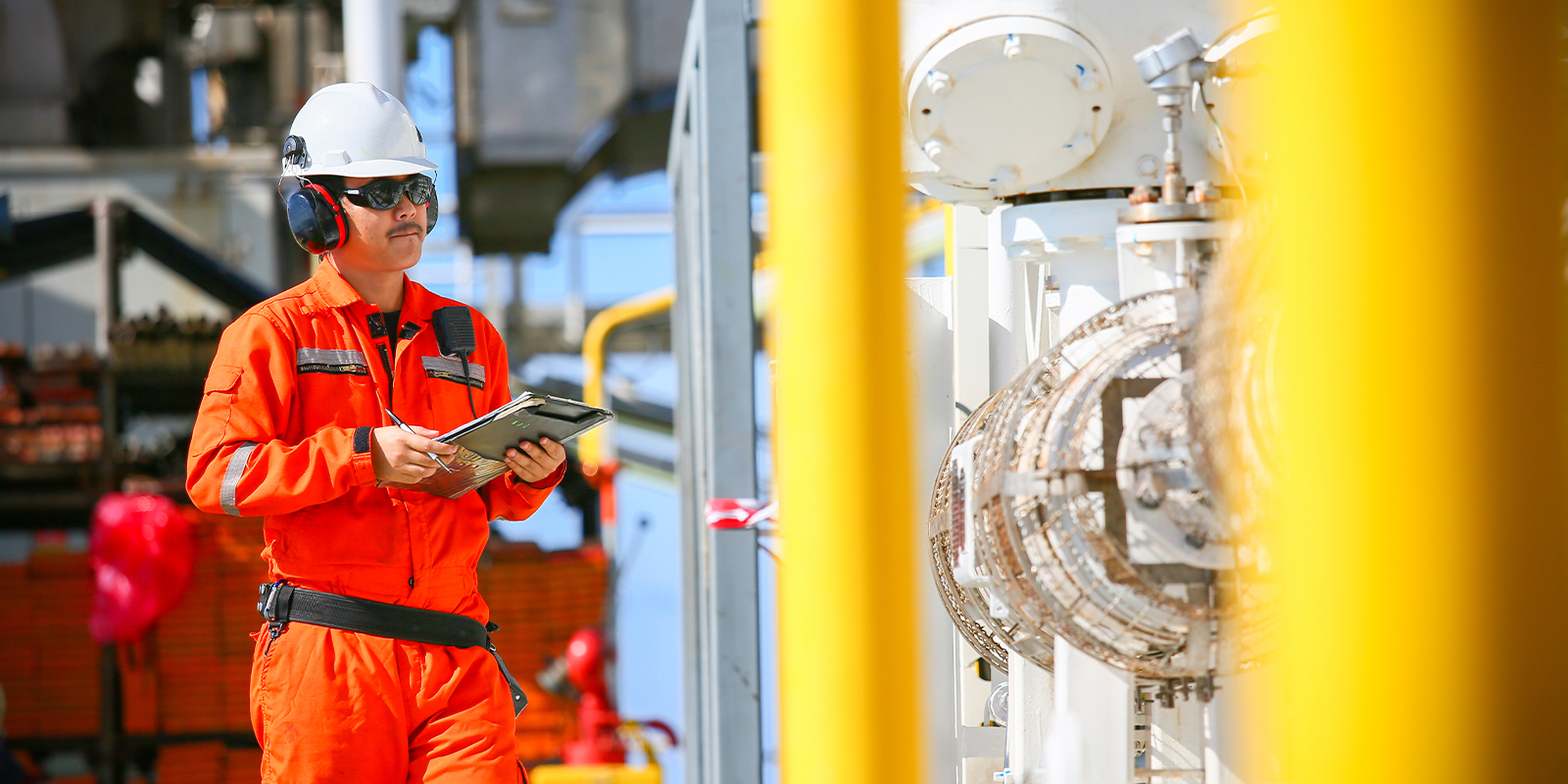 Worker on an offshore oil platform checking equipment